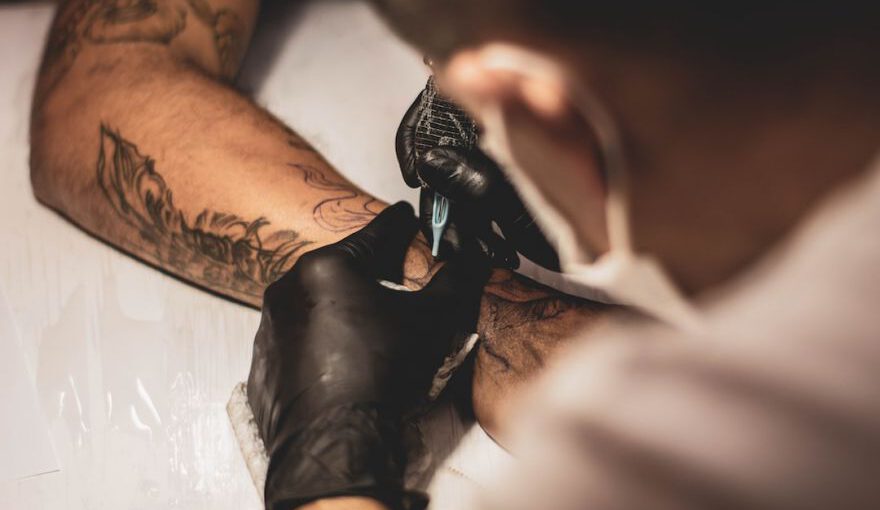 Tattoo - shallow focus photo of person tattooing person's right arm