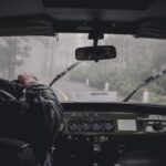 Drive License - man driving car during rainy daytime