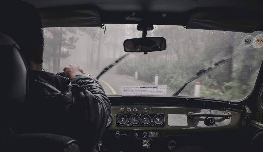 Drive License - man driving car during rainy daytime