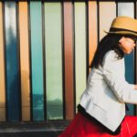 Cycling In Japan - woman wearing white blazer and brown hat riding bicycle