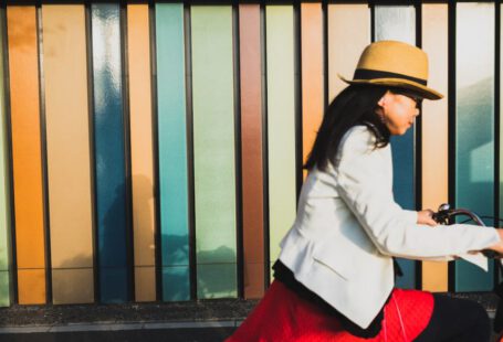 Cycling In Japan - woman wearing white blazer and brown hat riding bicycle