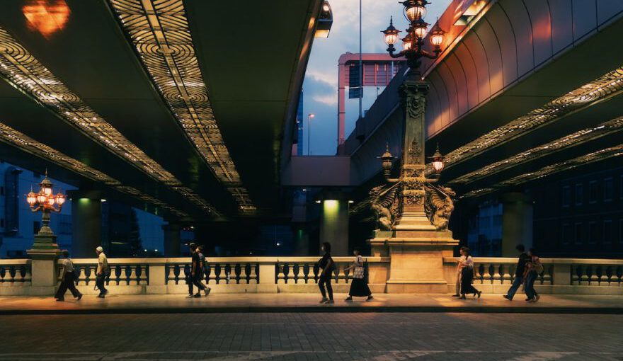 Japanese Summer - a group of people walking across a bridge