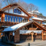 Japanese Onsen - brown wooden house near trees during daytime