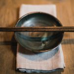 Chopstick - pair of brown chopsticks on round ceramic bowl