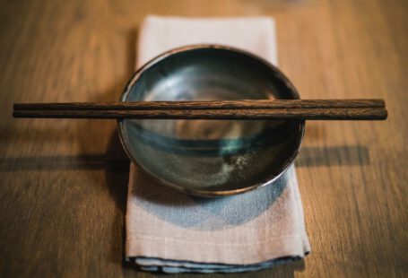 Chopstick - pair of brown chopsticks on round ceramic bowl