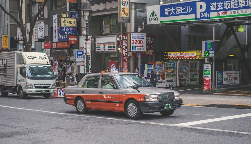 Japanese Taxis - red and grey car on road