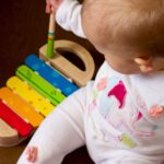 Japan Kid Activities - baby playing multicolored xylophone toy