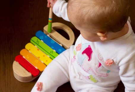 Japan Kid Activities - baby playing multicolored xylophone toy