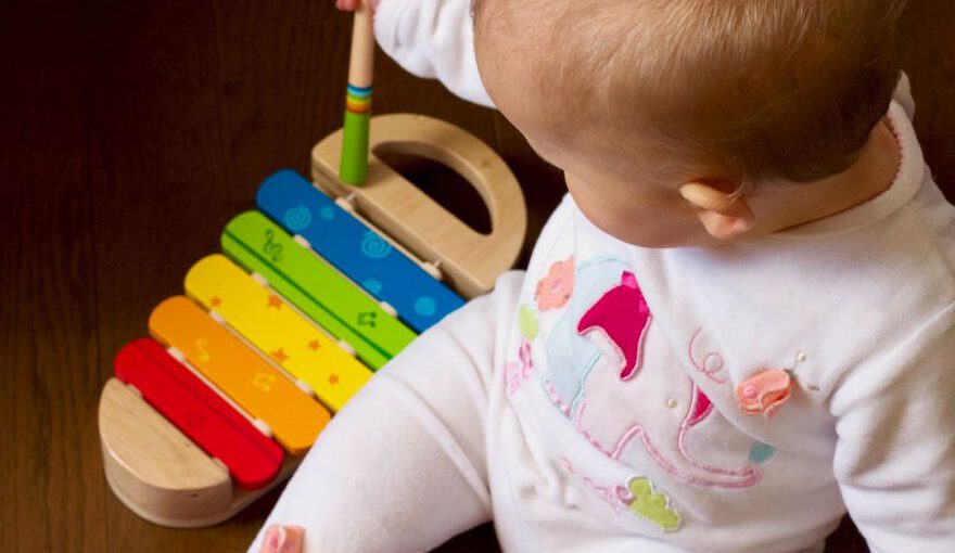 Japan Kid Activities - baby playing multicolored xylophone toy