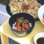 Japanese Dishes - a yellow table topped with bowls of food