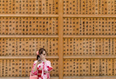 Japanese Traditions - girl in pink and white floral dress covering her face with her hands