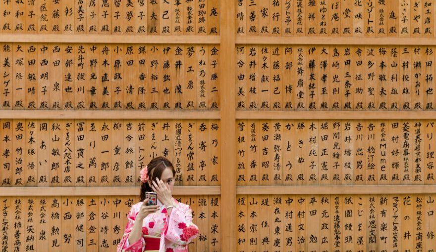 Japanese Traditions - girl in pink and white floral dress covering her face with her hands