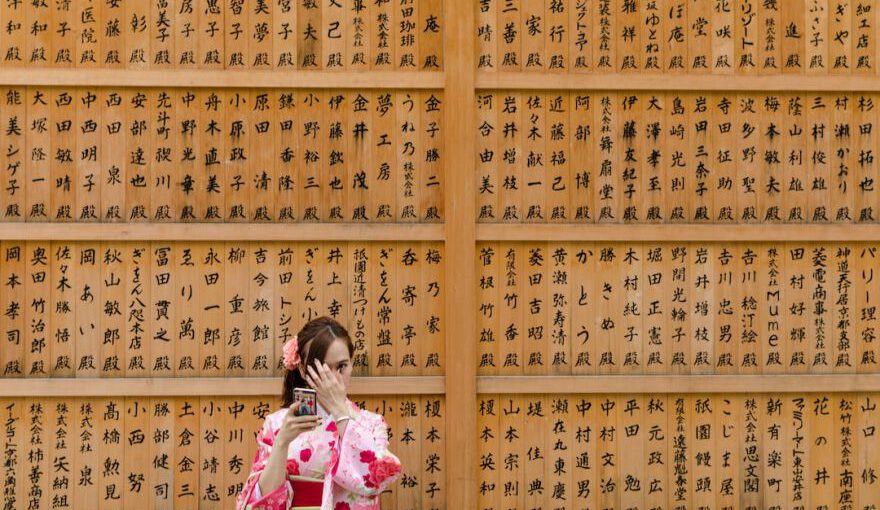 Japanese Traditions - girl in pink and white floral dress covering her face with her hands