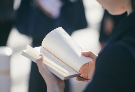 Learn Japanese - standing woman reading book at daytime