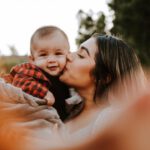 Love Hotels Japan - woman kiss a baby while taking picture