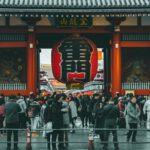 Japanese Society - people standing on concrete castle at daytime