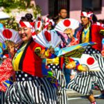 Japan Festival - people in red and black traditional dress standing on street during daytime