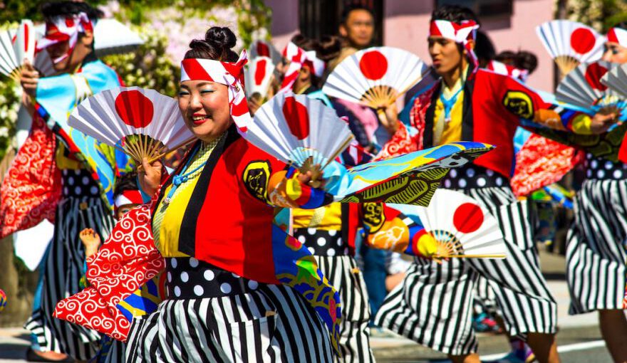 Japan Festival - people in red and black traditional dress standing on street during daytime