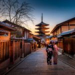 Japanese Culture - two women in purple and pink kimono standing on street