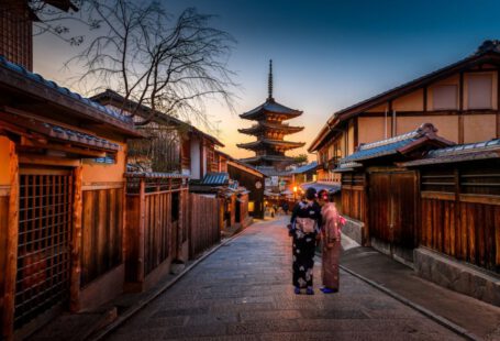 Japanese Culture - two women in purple and pink kimono standing on street