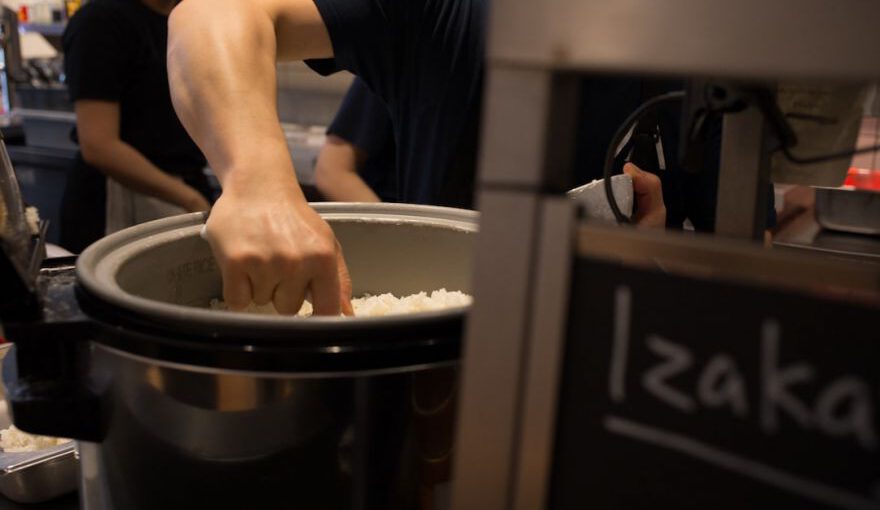 Japanese Omiyage - a man putting rice into a large pot