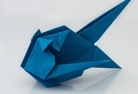 Japanese Origami - a blue origami bird sitting on top of a table