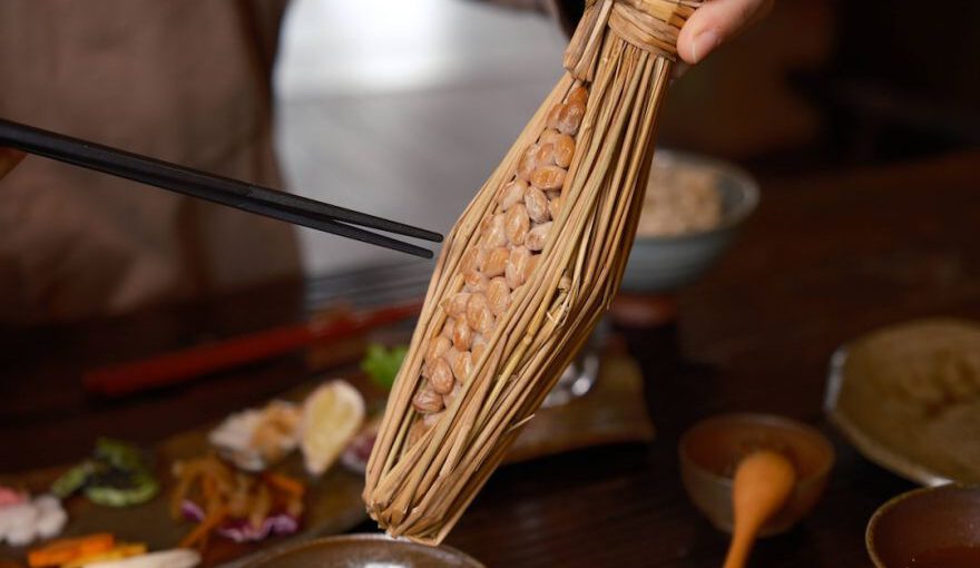 Japanese Breakfast - a person holding a stick over a bowl of food