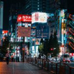 Tokyo Nightlife - a city street at night with tall buildings