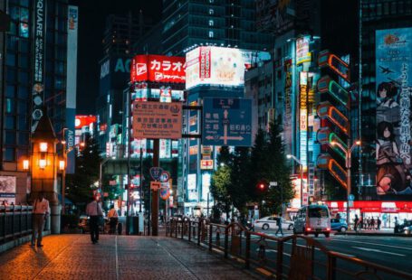 Tokyo Nightlife - a city street at night with tall buildings
