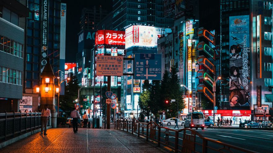 Tokyo Nightlife - a city street at night with tall buildings