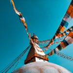 Unesco - shallow focus photography of buntings tied on building roof at daytime