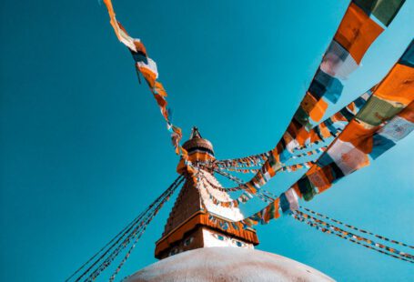 Unesco - shallow focus photography of buntings tied on building roof at daytime