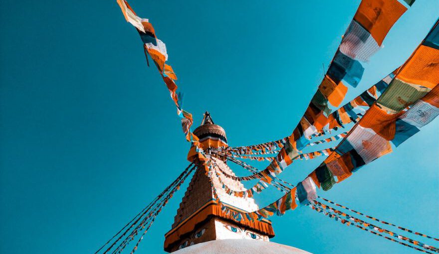 Unesco - shallow focus photography of buntings tied on building roof at daytime