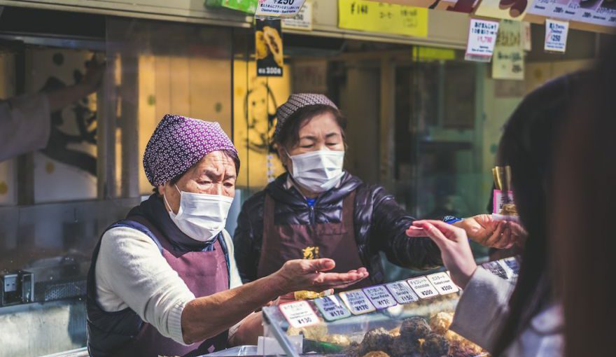 Japanese Masks - two vendors accommodating customer